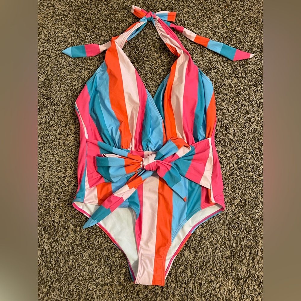 One piece plunge neckline tie waist swimsuit, never worn. Vibrant colors!